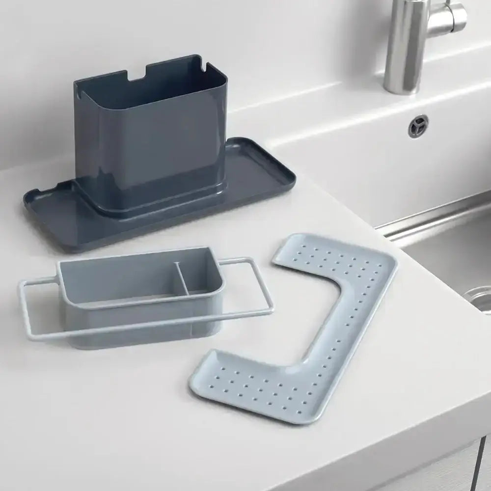 Set of gray kitchen sink organizers on a white countertop.