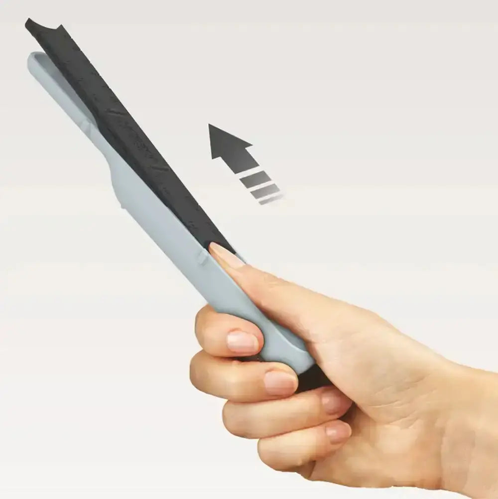 Hand holding an adjustable measuring spoon with a clear background
