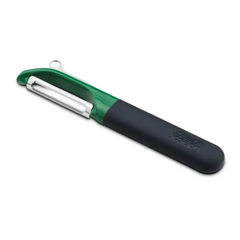 Green and black vegetable peeler with silver blade on a white background