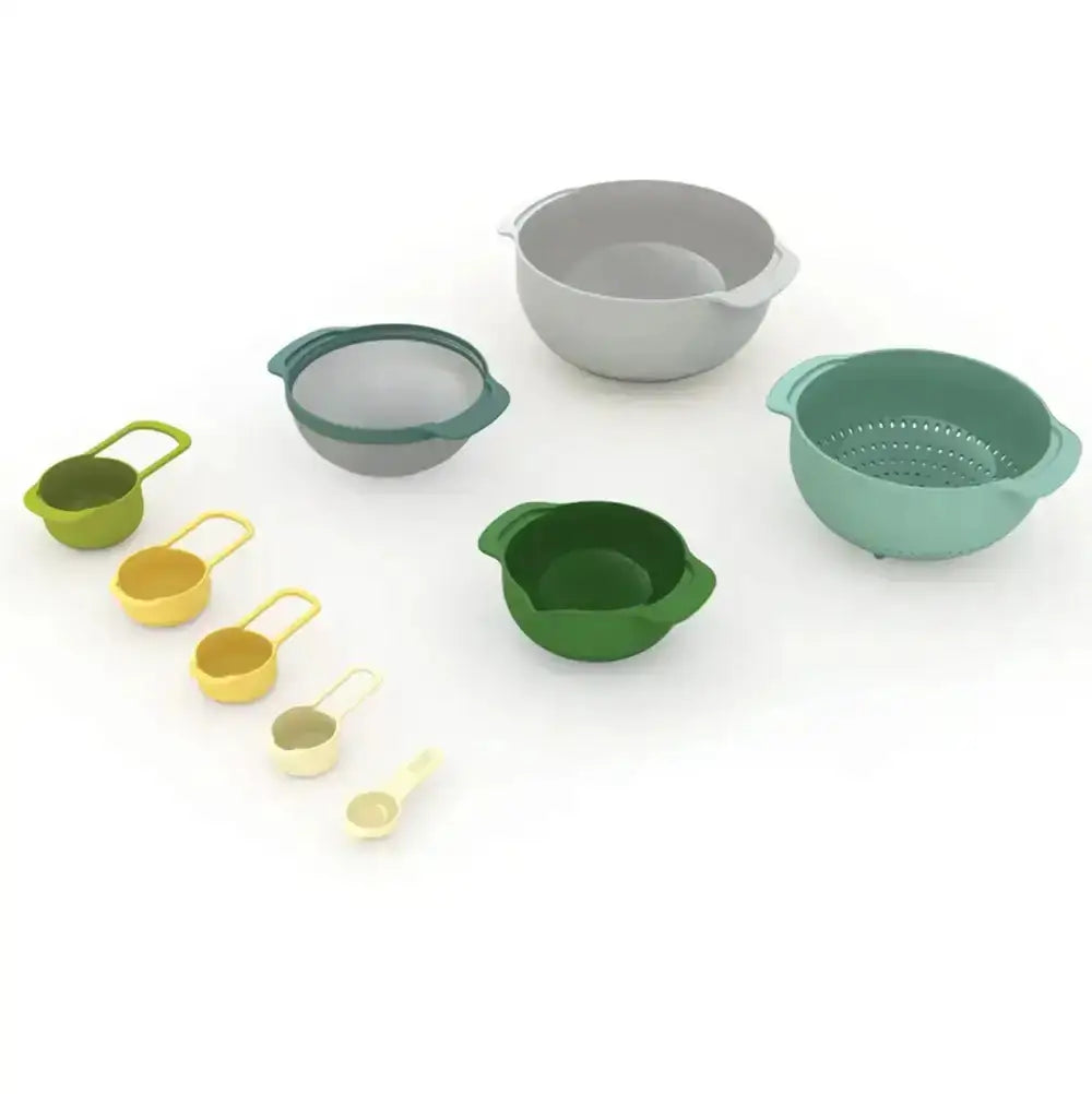 Set of kitchen utensils including bowls, measuring cups, and a strainer on a white background