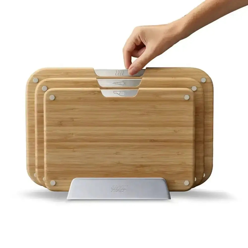 Set of bamboo cutting boards with a stand on a white background