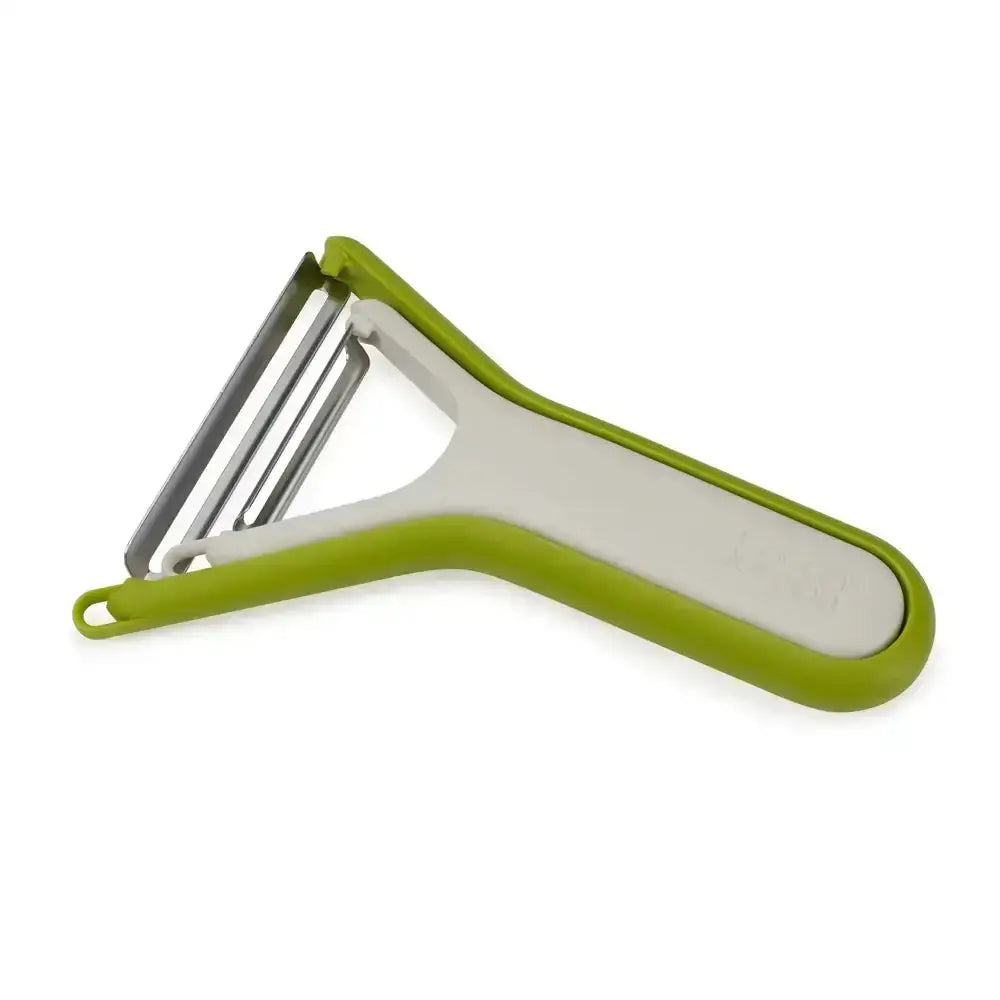 Green and white vegetable peeler on a white background