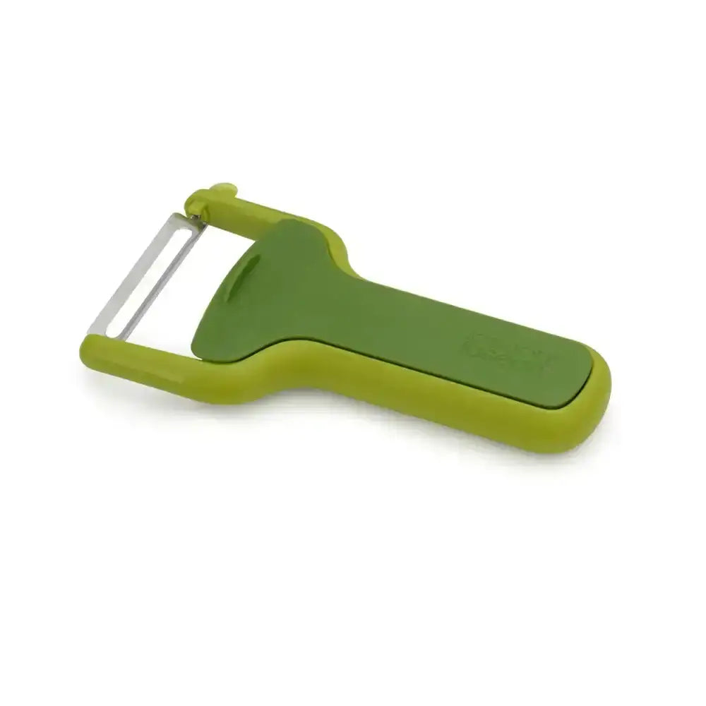 Green vegetable peeler on a white background
