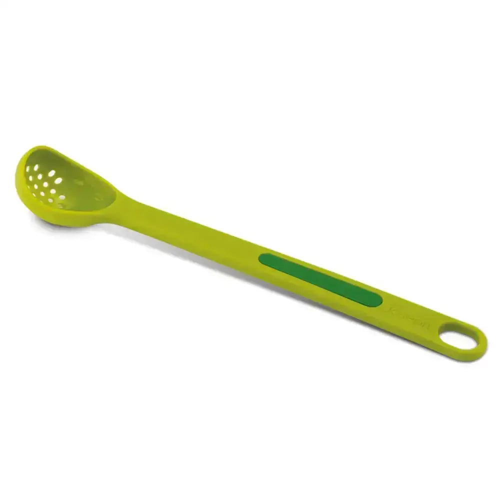 Green kitchen spoon with perforated end on a white background