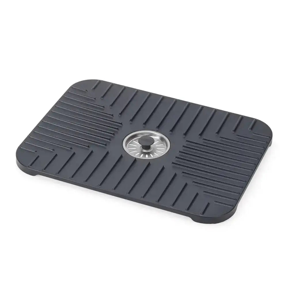 Black rubber mat with a central drain hole on a white background