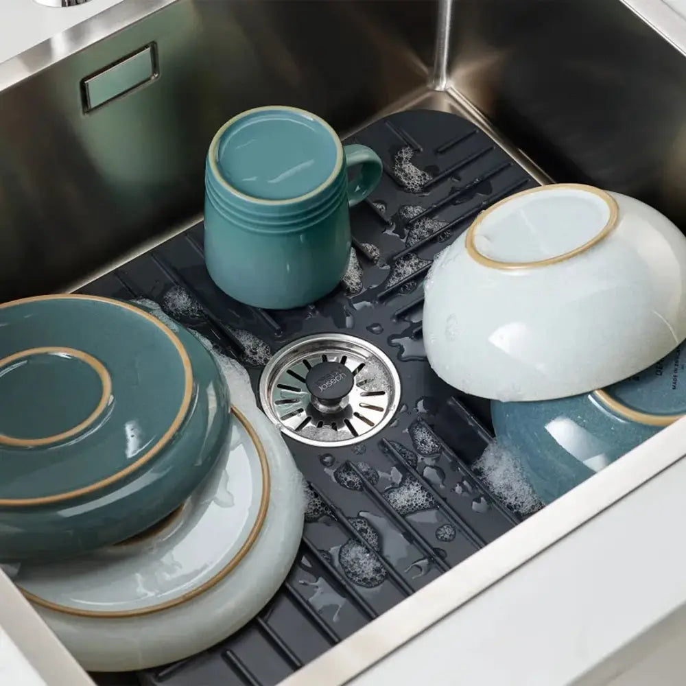 Dishwasher with green and white dishes in a kitchen setting
