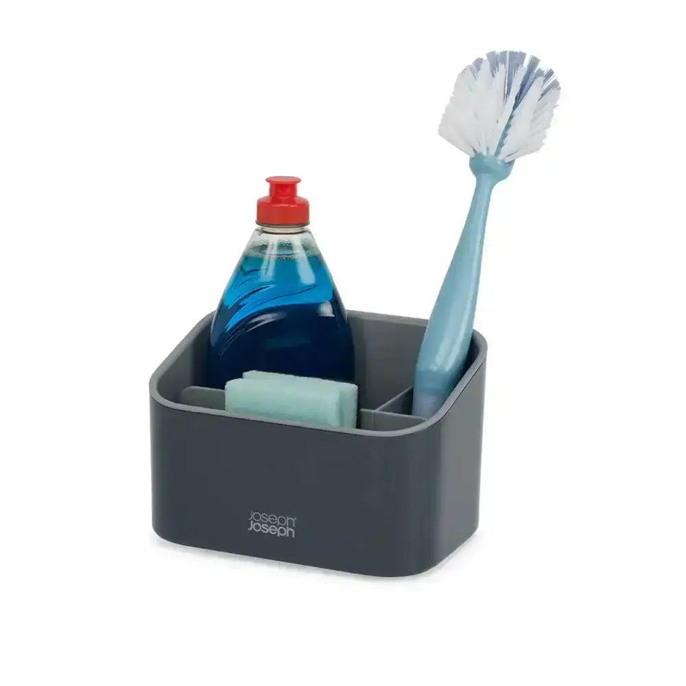 Gray caddy with Joseph Joseph logo containing a bottle of dish soap, sponge, and brush on a white background