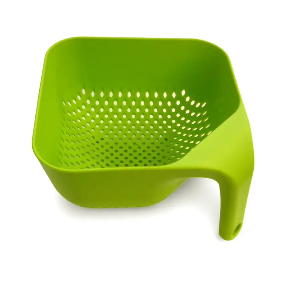Green plastic colander on a white background