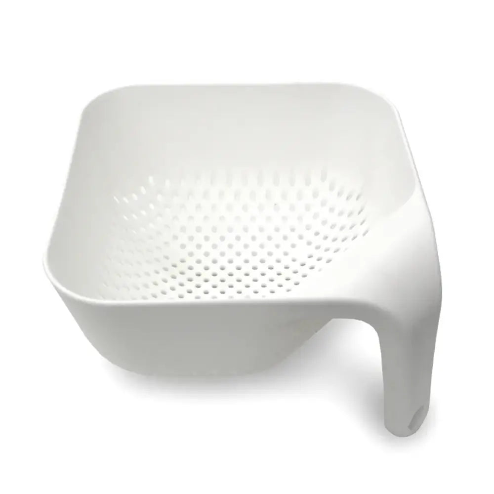 White plastic colander with holes on a white background