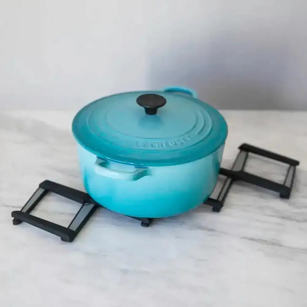 Blue cast iron pot with lid on a marble surface