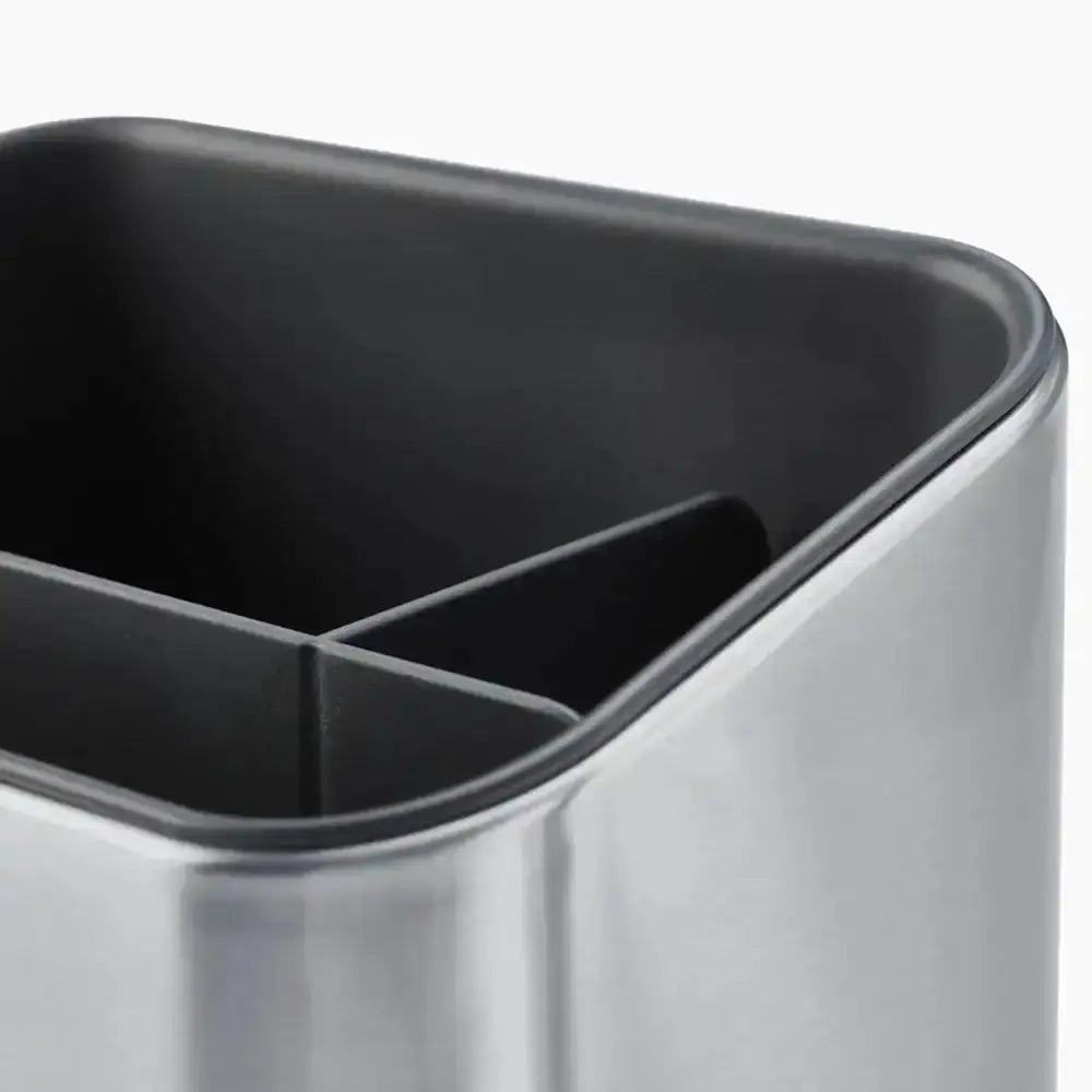 Close-up of a metallic container with black interior