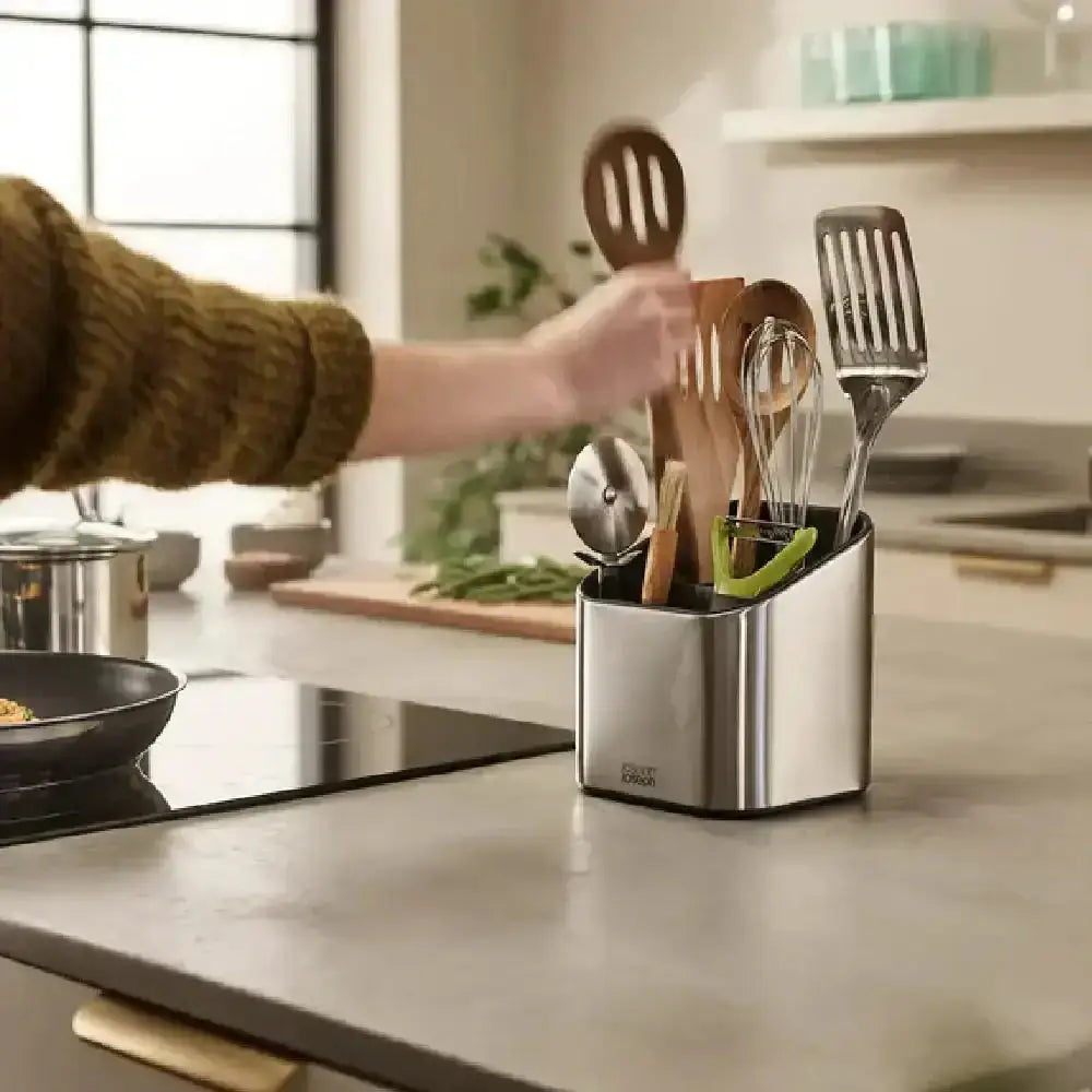 Kitchen utensil holder with utensils on a kitchen counter