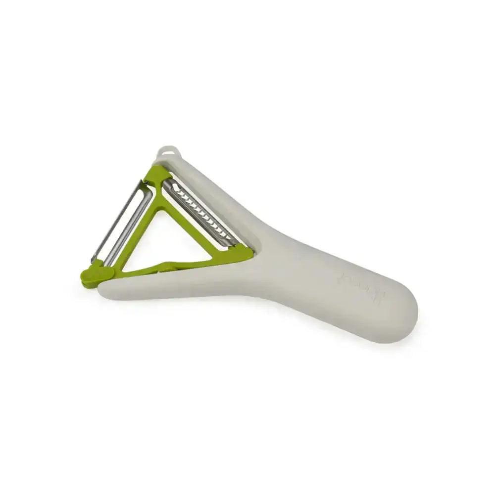 Peeler with green handle and white body on a white background