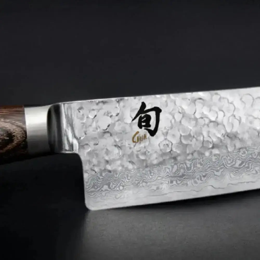 Chef's knife with a decorative blade on a dark background
