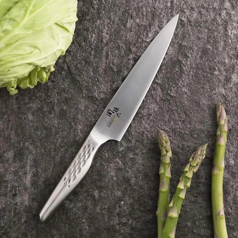 Knife on a stone surface with asparagus and cabbage