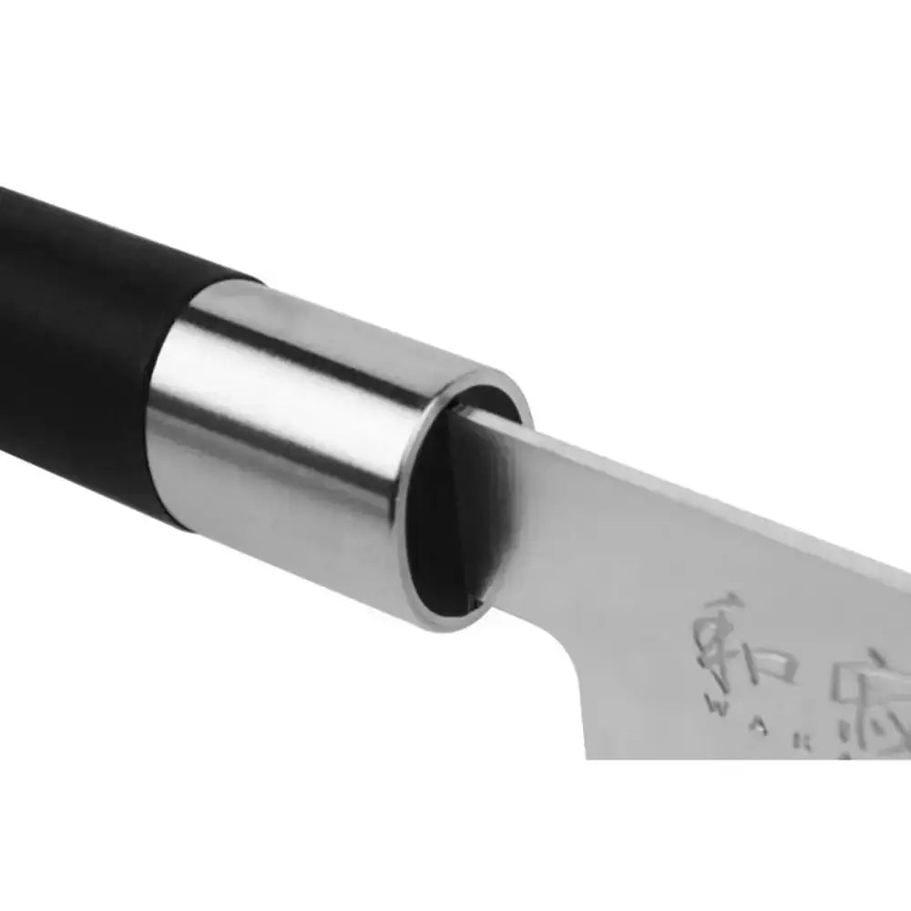 Close-up of a knife with a black handle and silver blade on a white background