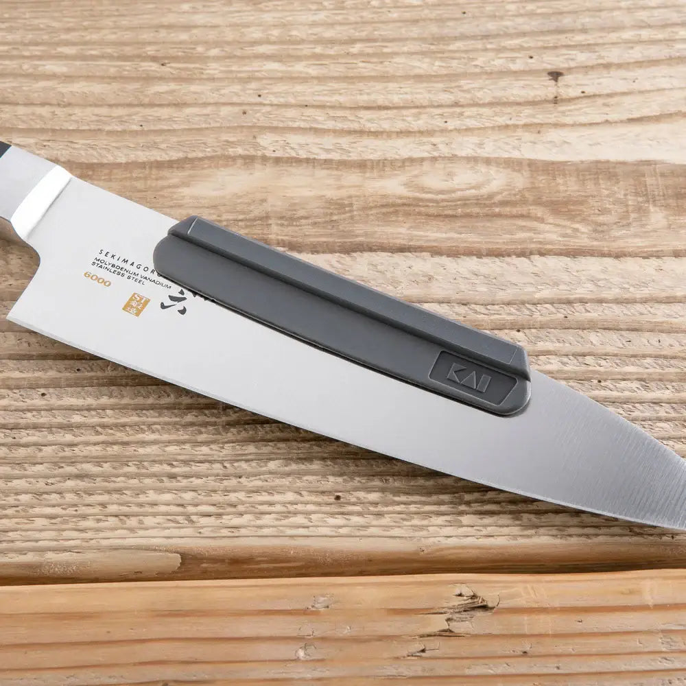 Kai Shun sharpening aid on a knife, on a table