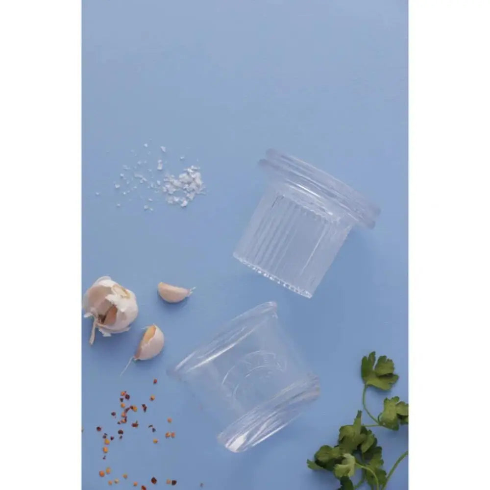 Clear glass containers with lids on a blue background
