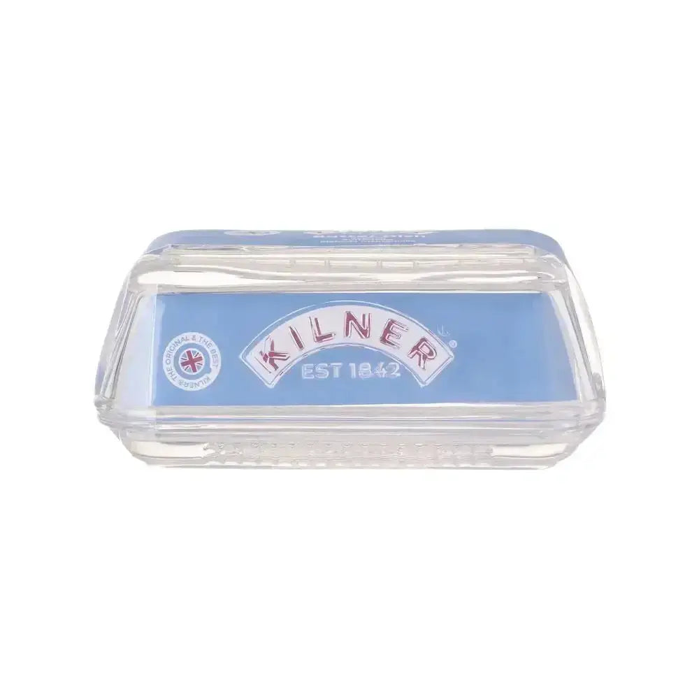 Clear glass butter dish with Kilner EST 1842 branding on a blue background.