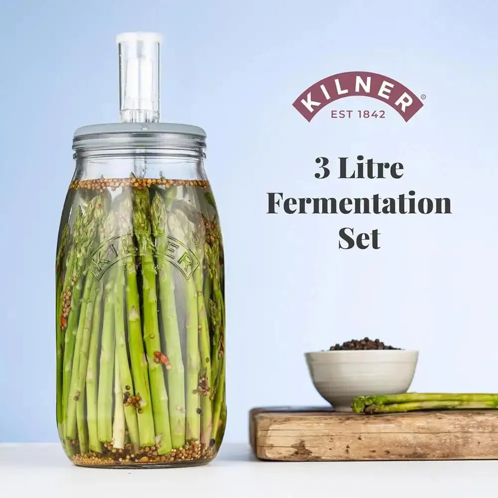 Kilner 3 Litre Fermentation Set with asparagus and a bowl of spices on a light blue background.