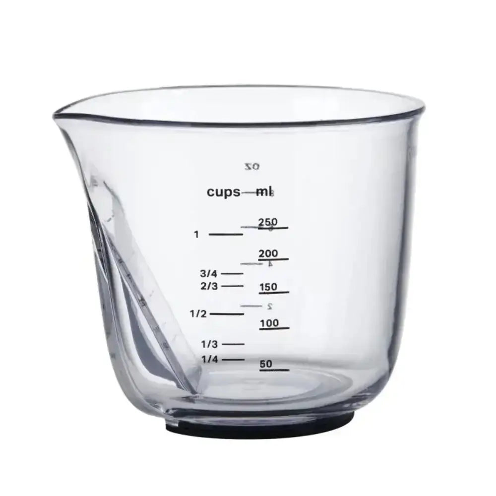 Clear glass measuring cup with volume markings on a white background