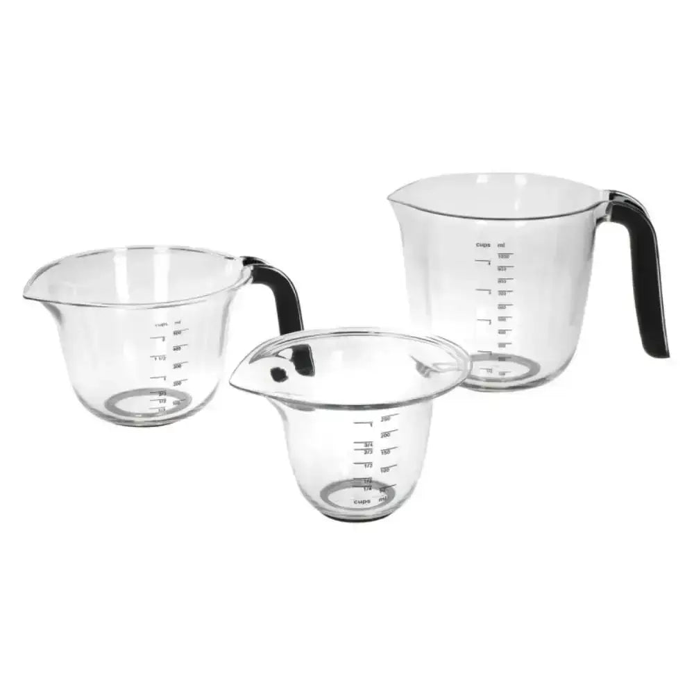 Set of three clear measuring cups with black handles on a white background