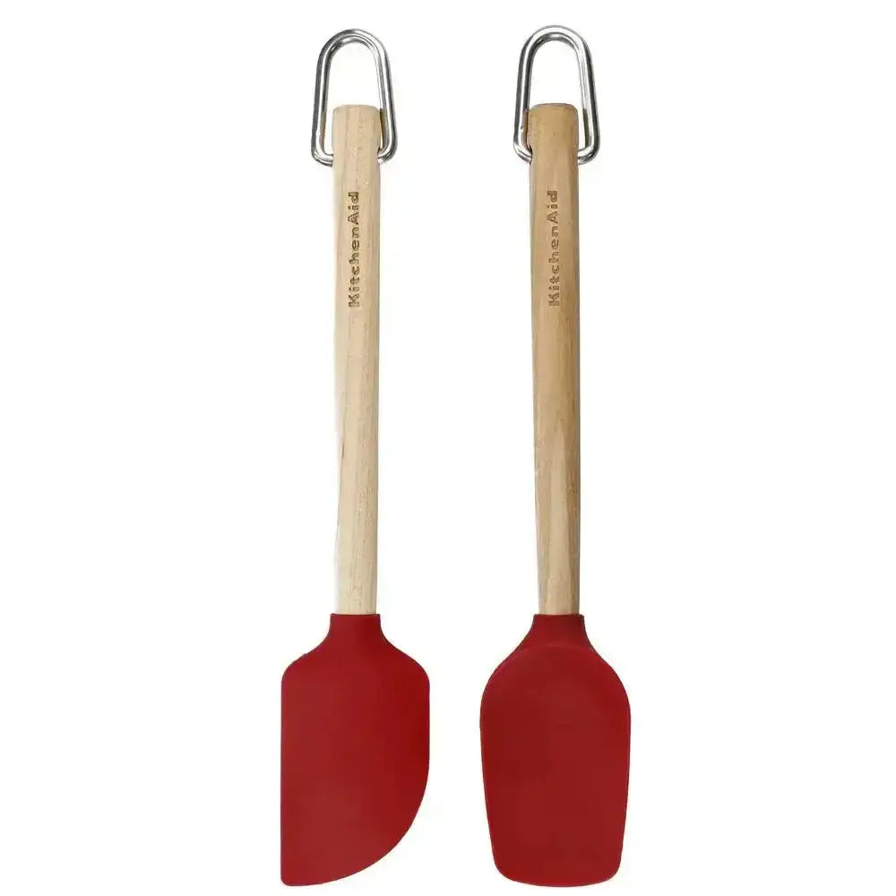 Two red spatulas with wooden handles on a white background