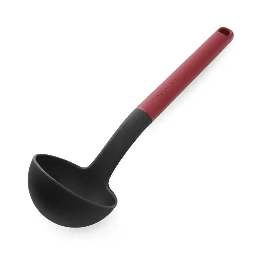 Black ladle with a red handle on a white background