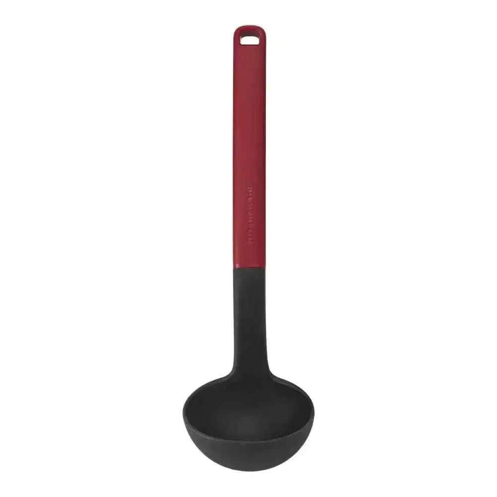 Black ladle with a red handle on a white background