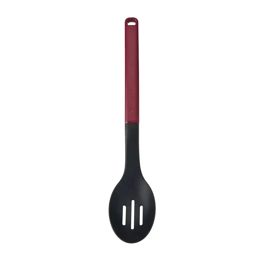 Black slotted spoon with a red handle on a white background