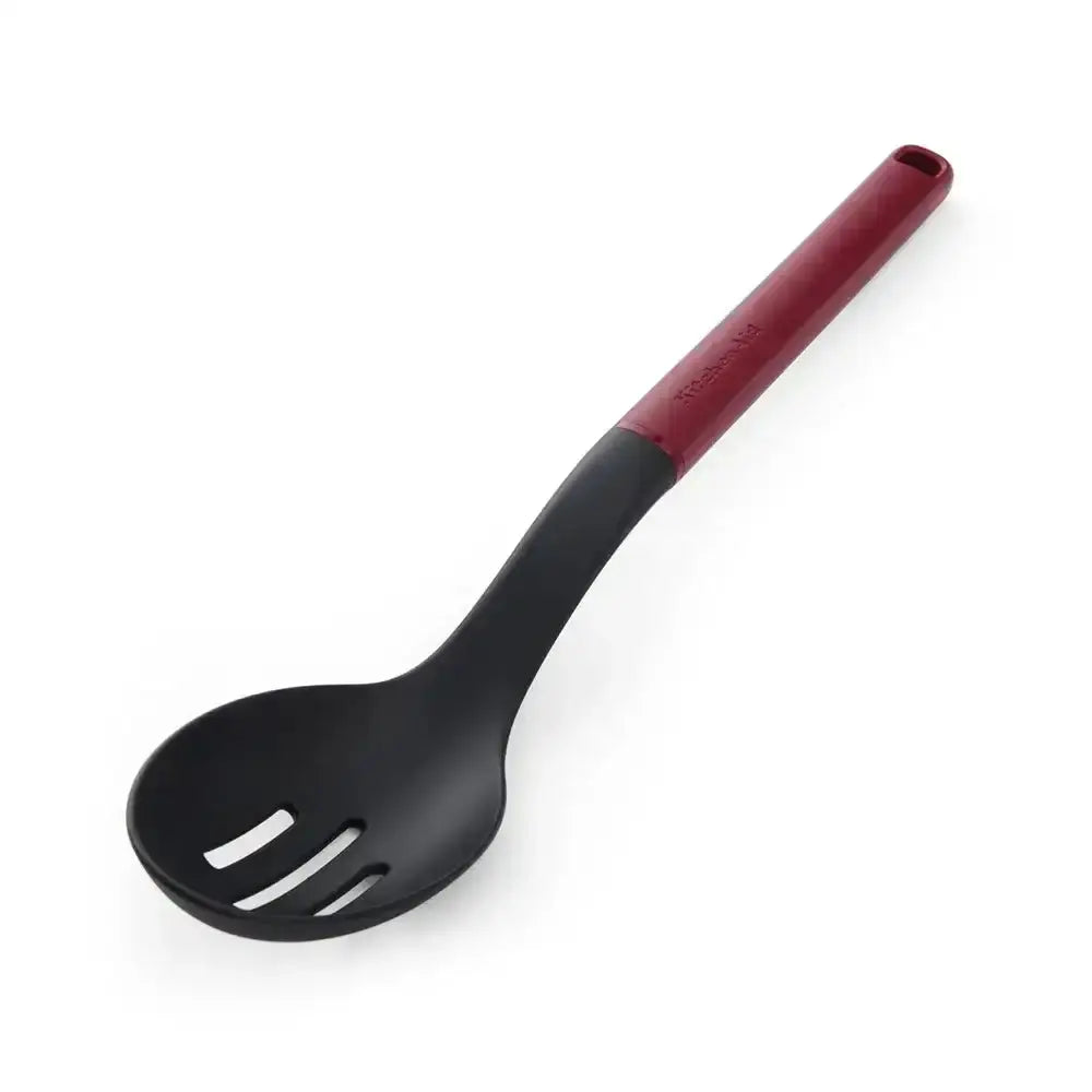 Black ladle with a red handle on a white background