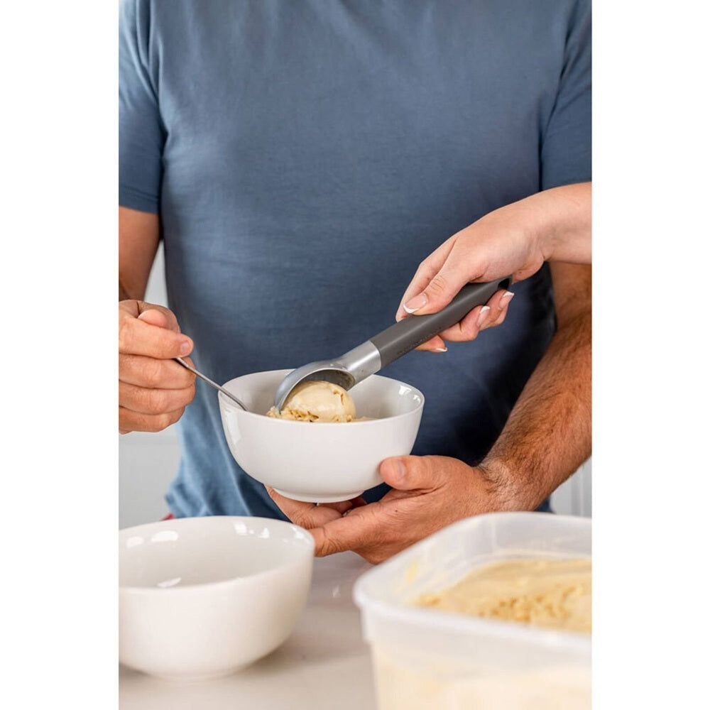 KitchenAid classic stainless steel ice cream scoop in gray and silver with a smooth ergonomic handle for easy scooping