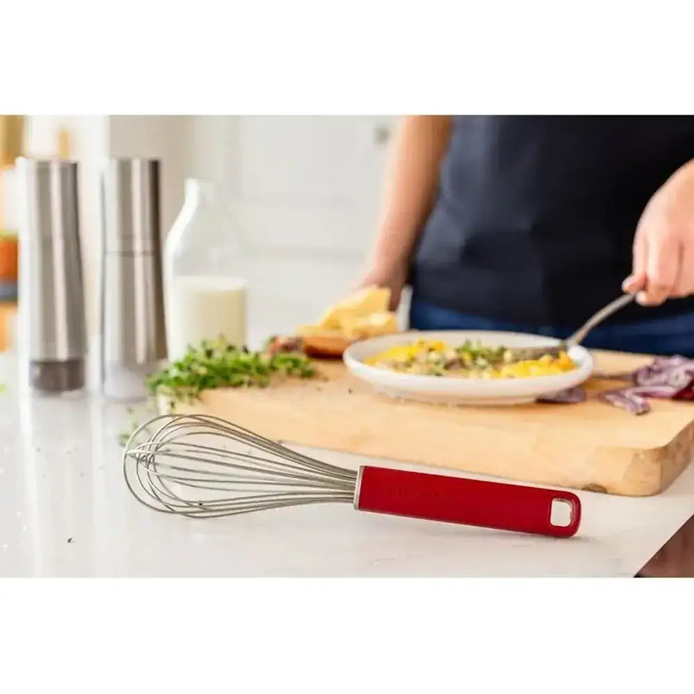 Person cooking with a whisk on a kitchen counter