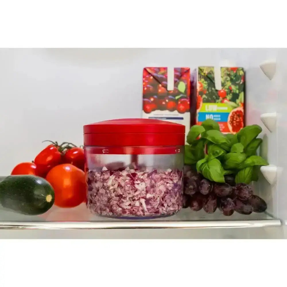 Red container with chopped onions on a refrigerator shelf with vegetables and fruit packaging.