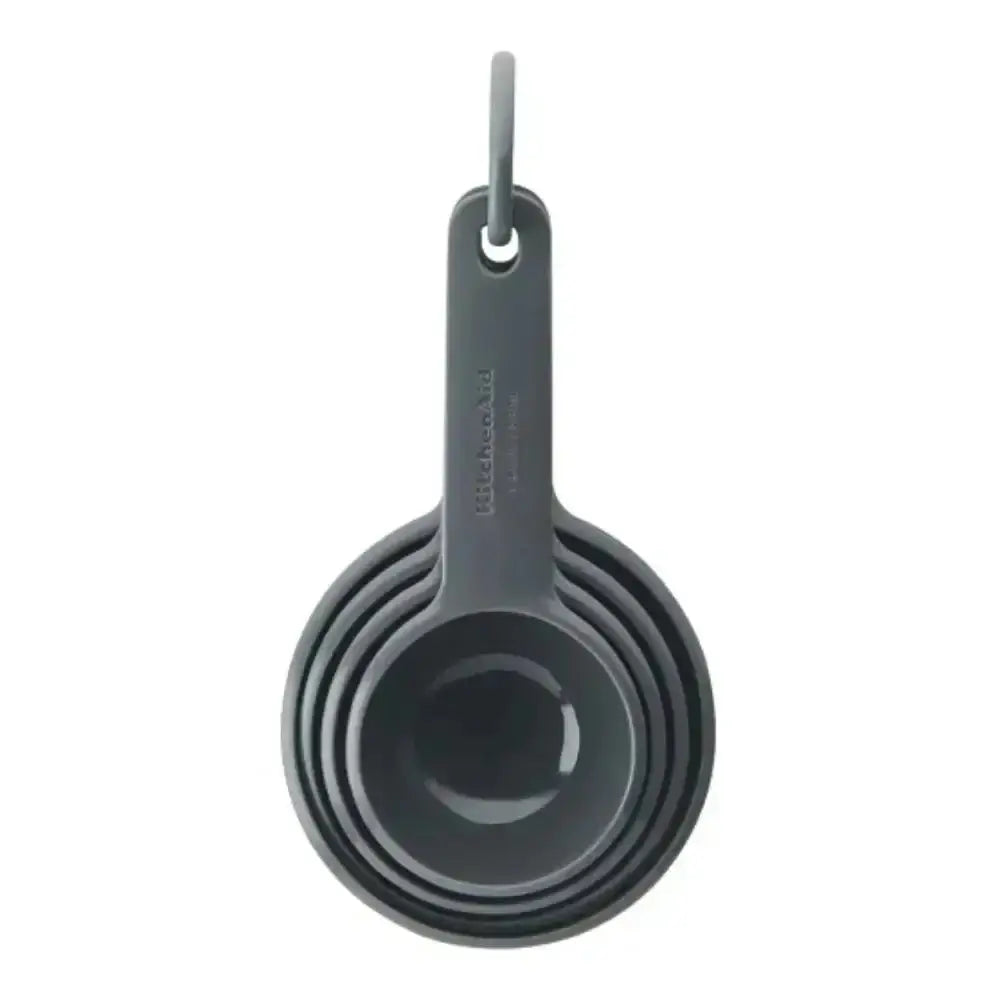 Set of gray measuring cups with a hanging hook on a white background