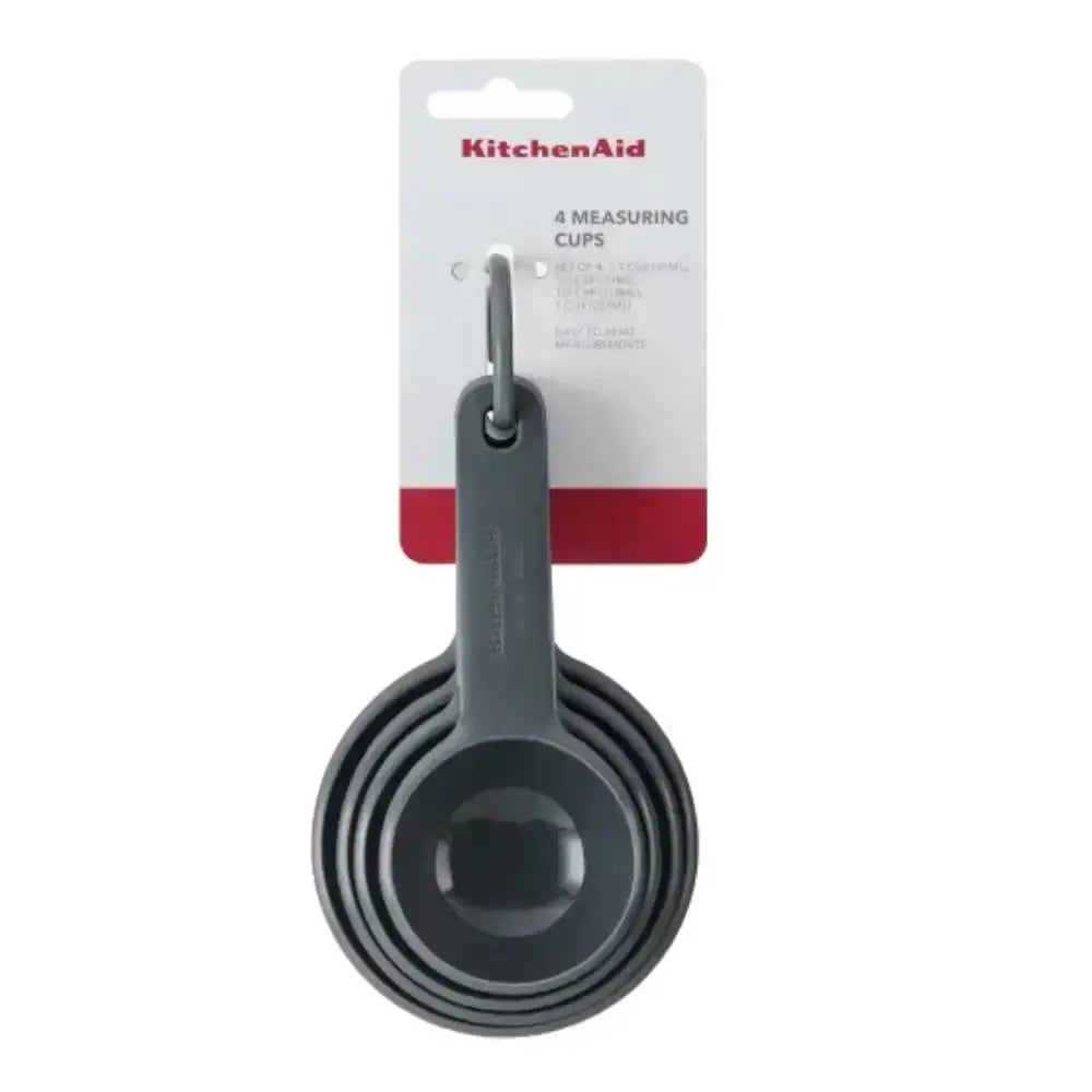 Set of gray measuring cups on a white background with KitchenAid packaging.