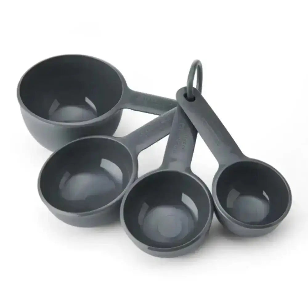 Set of four gray measuring cups with a hanging ring on a white background
