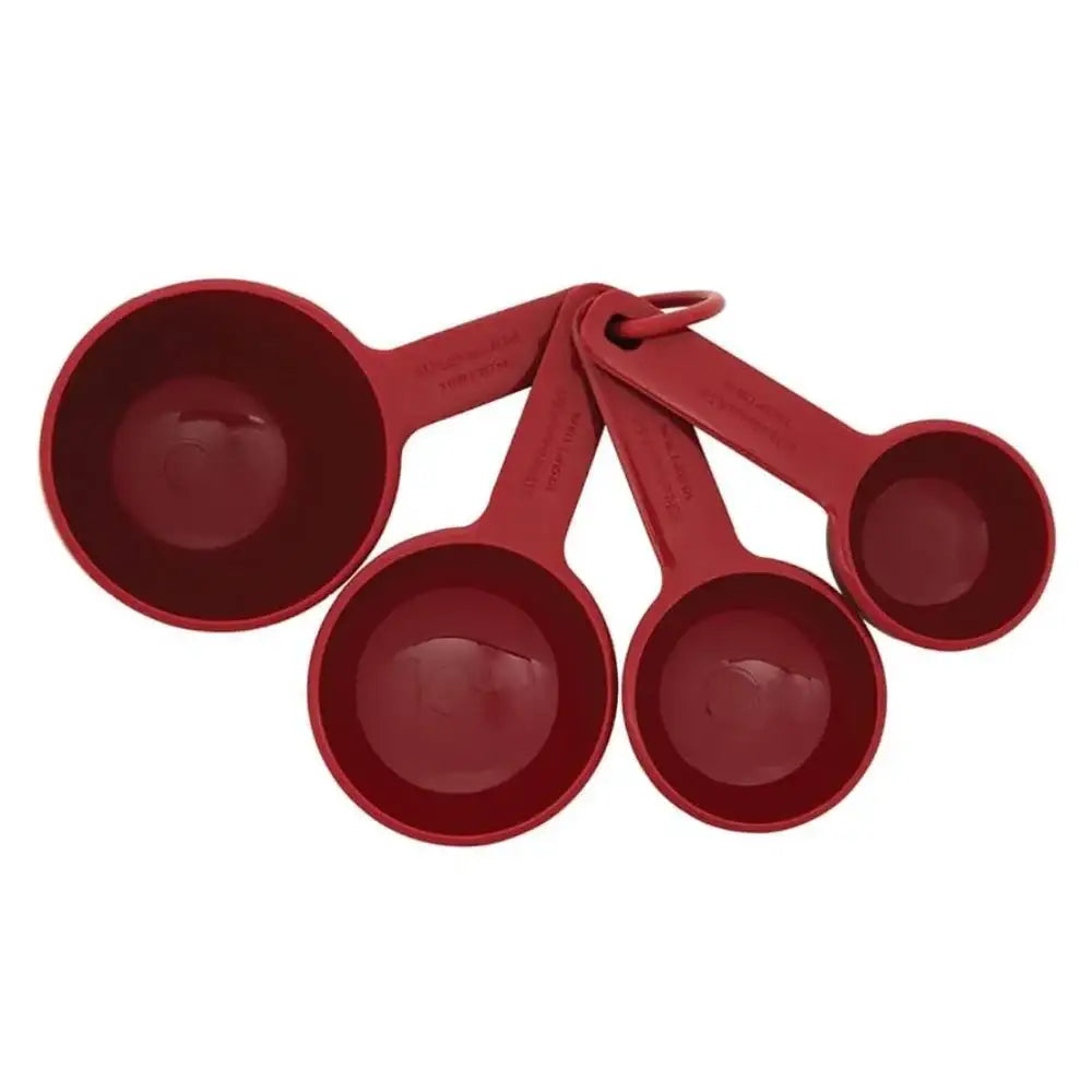 Set of four red measuring cups on a white background