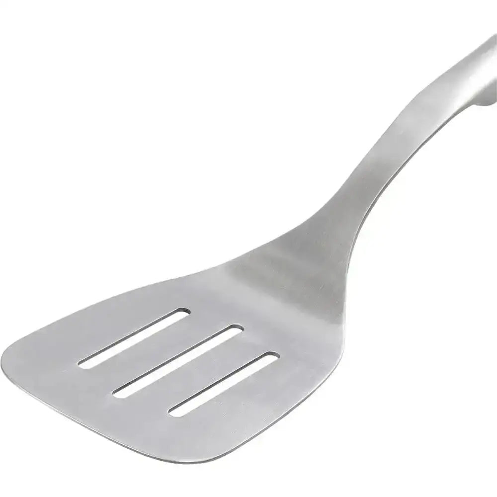 Metallic slotted spatula on a white background