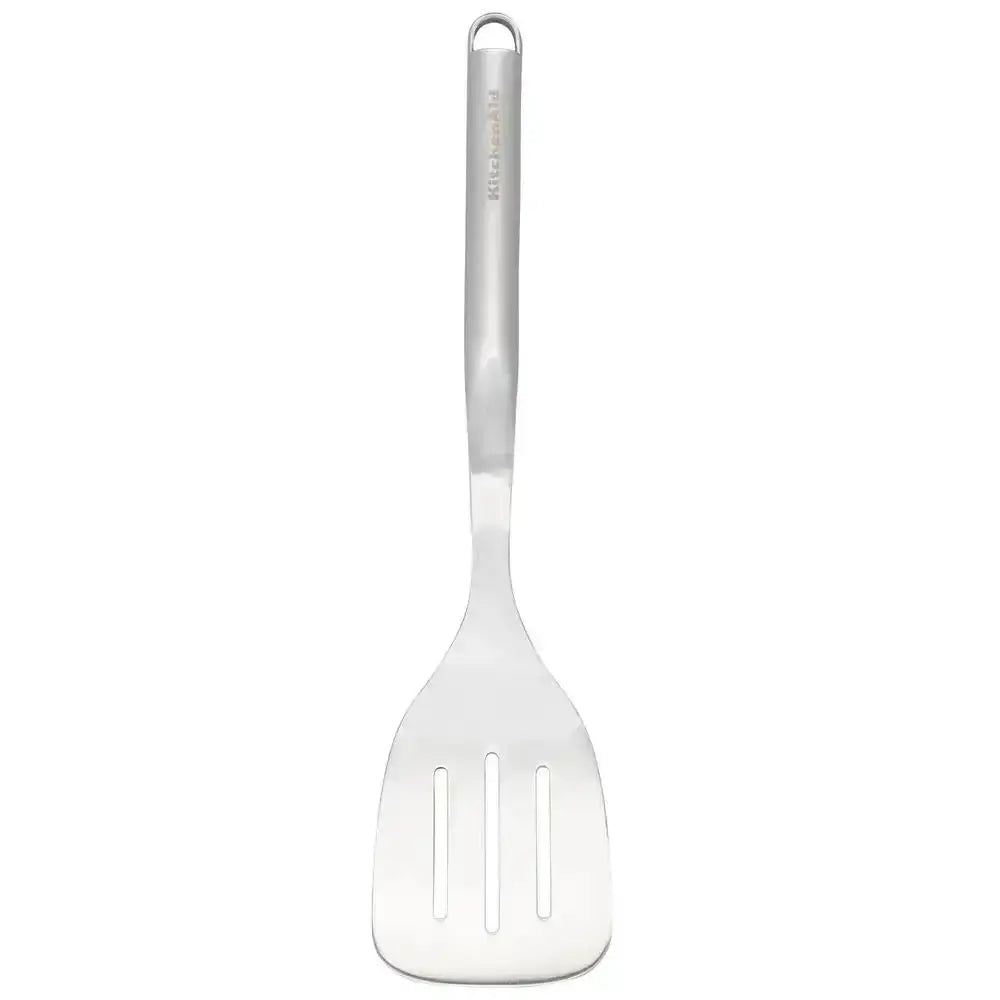 Metallic slotted spoon on a white background
