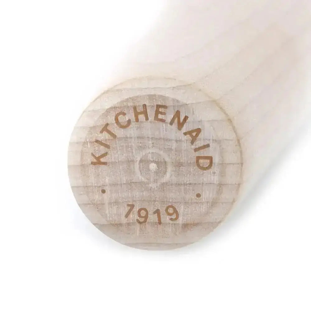 Wooden paddle with 'KitchenAid' branding on a white background
