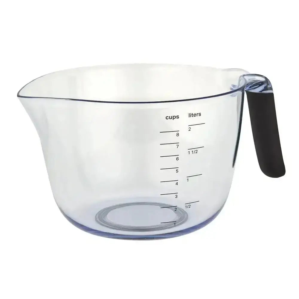 Clear measuring cup with black handle on a white background