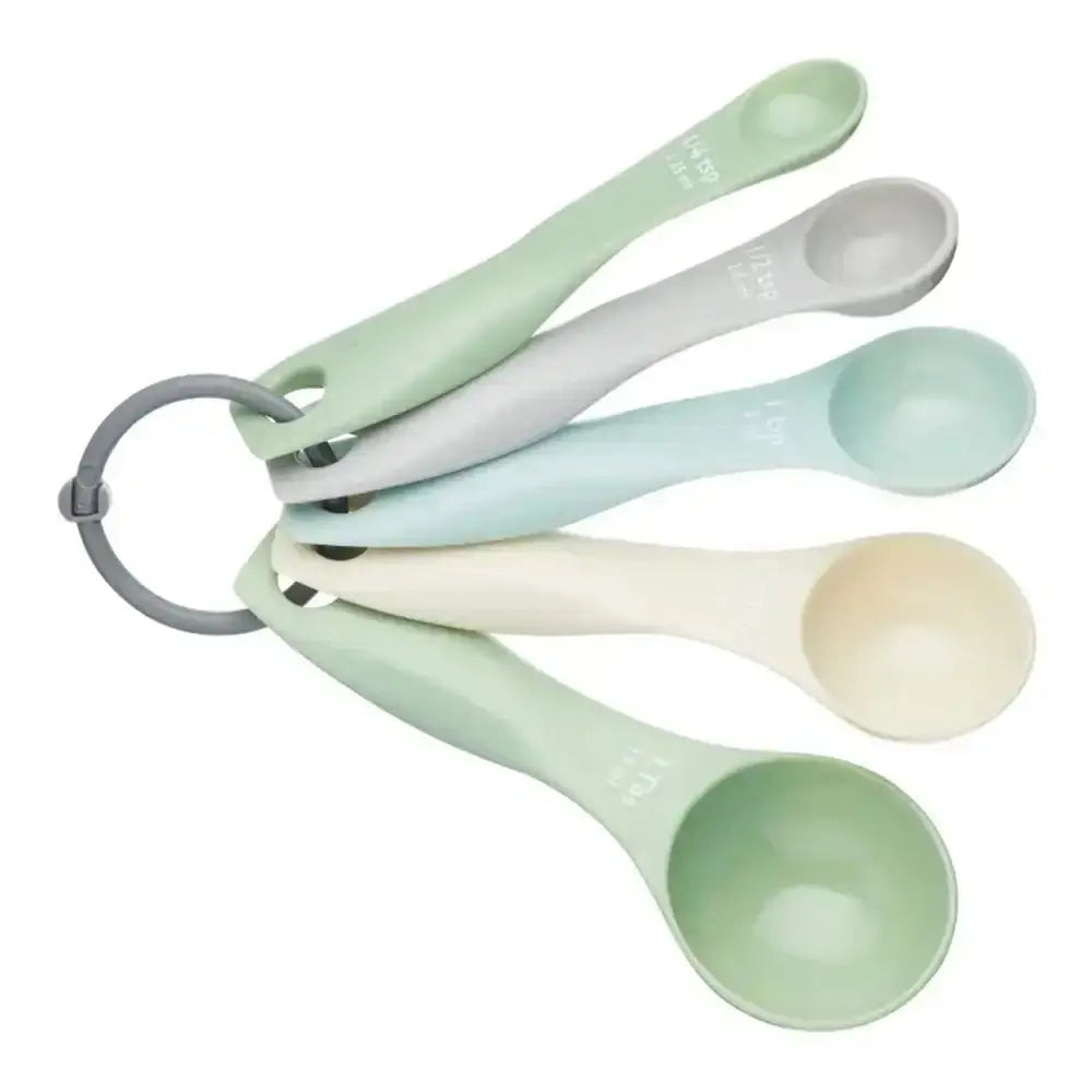 Set of measuring spoons in pastel colors on a white background