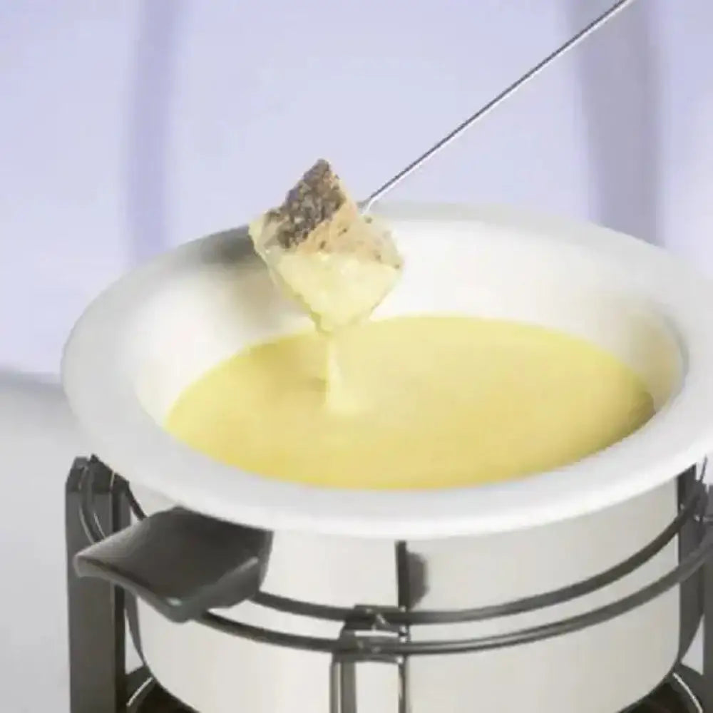 Fondue pot with cheese and a piece of bread being dipped into it.