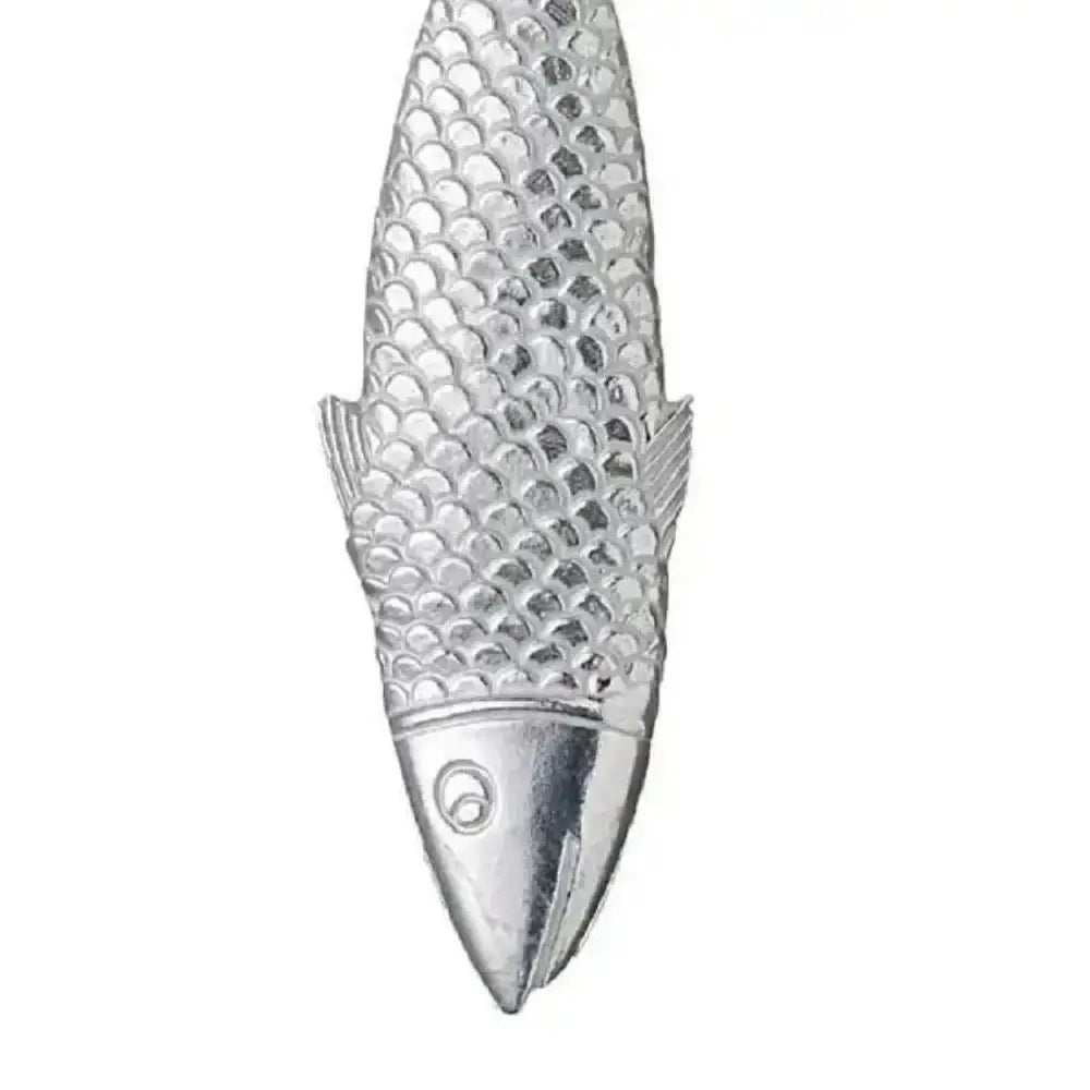 Silver fish-shaped object on a white background