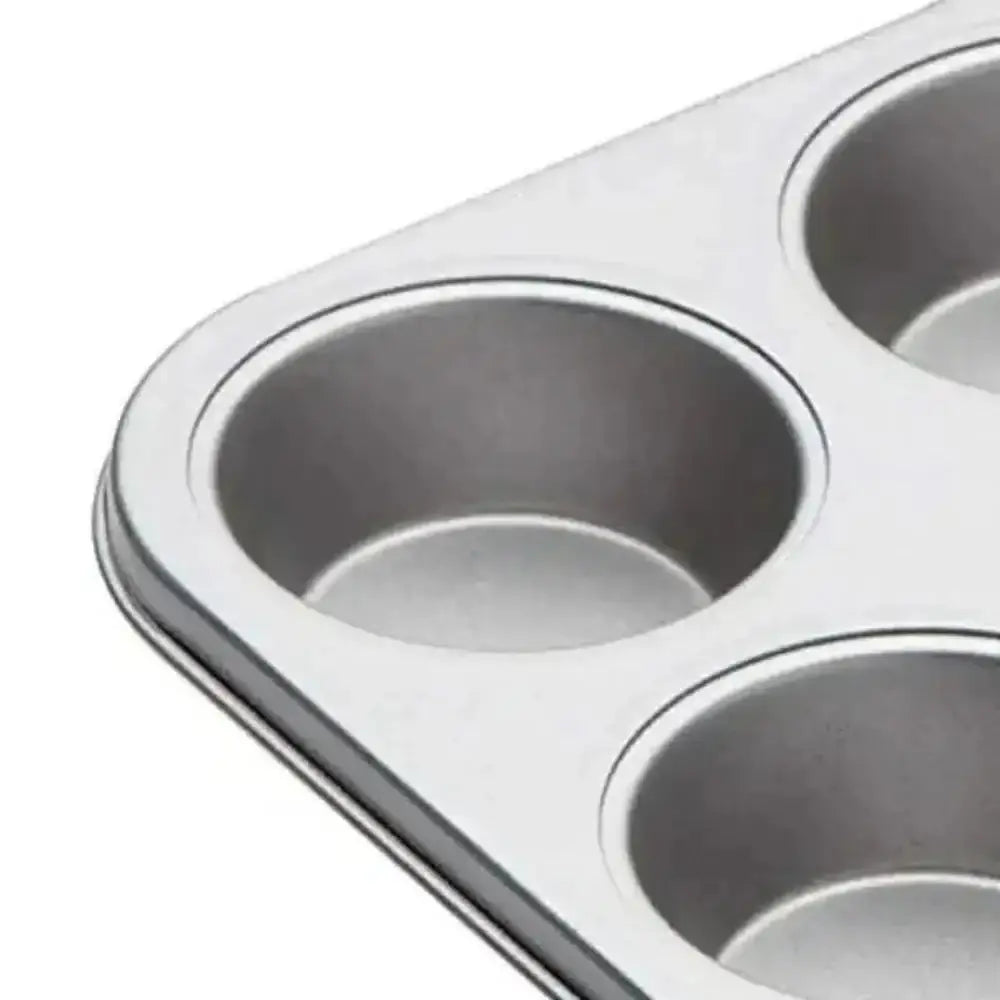 Metal muffin tin with four compartments on a white background