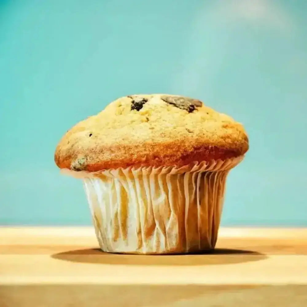 Muffin on a wooden surface with a blue background