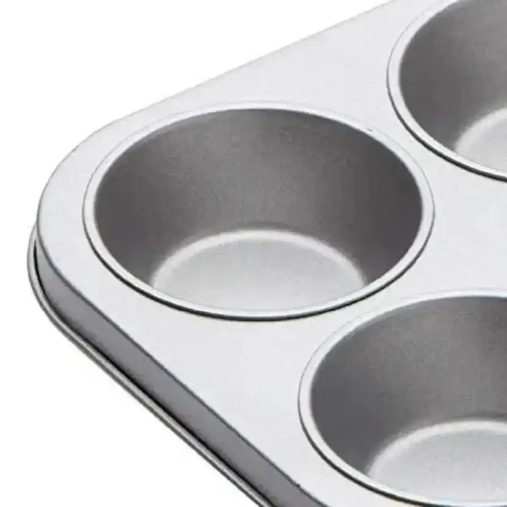 Metal muffin tin with four compartments on a white background