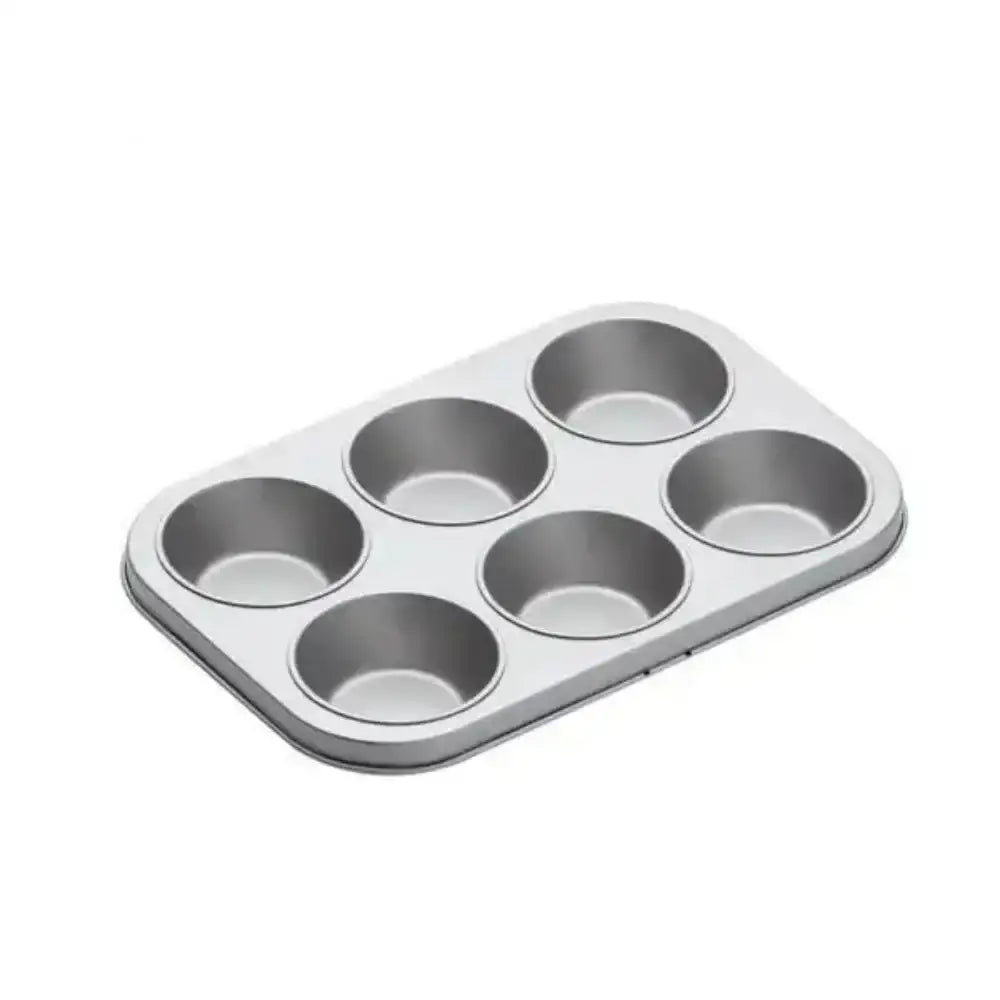Metal muffin tin with six compartments on a white background