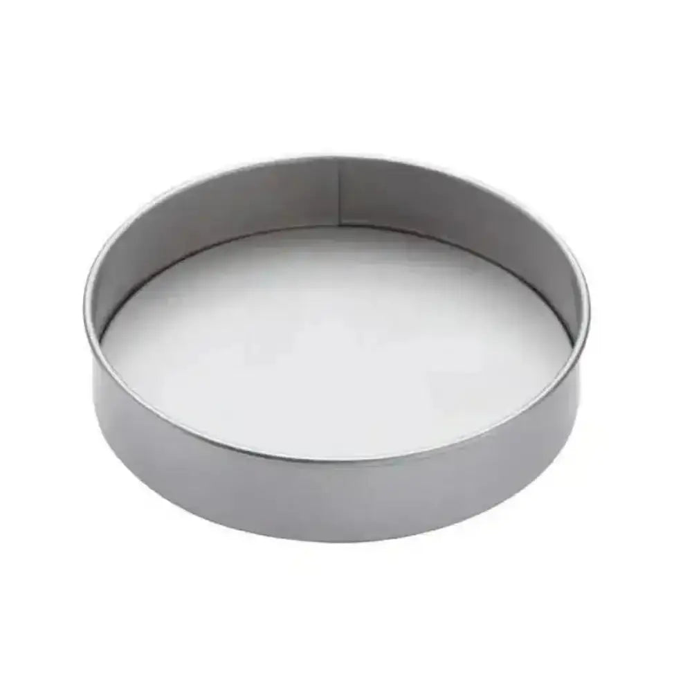 Metallic cake pan with a white interior on a white background